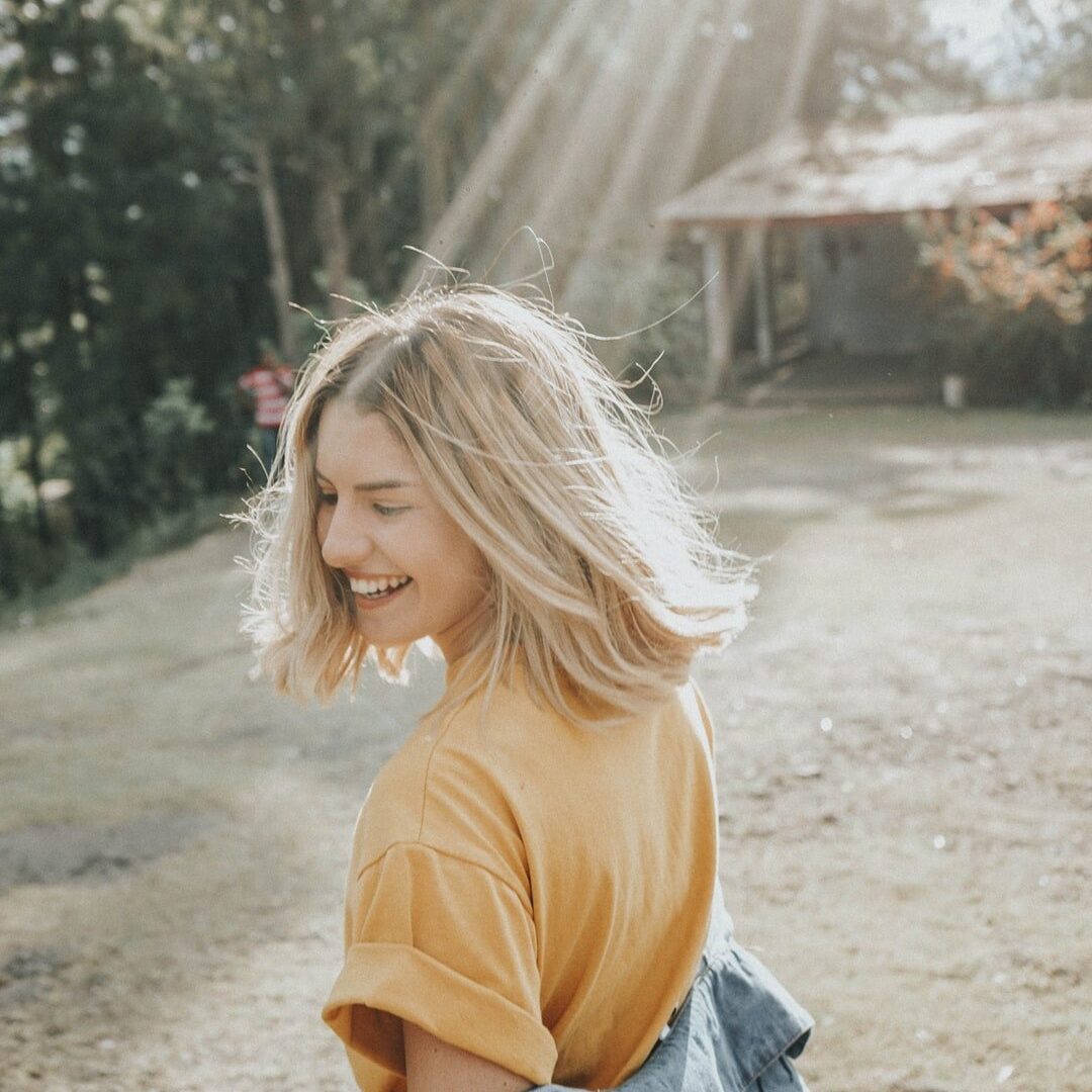 Woman in the park with a big smile on her face